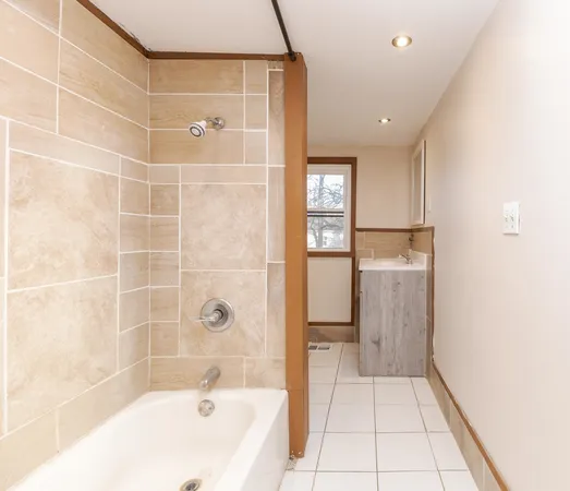a bathroom with a bathtub and a shower