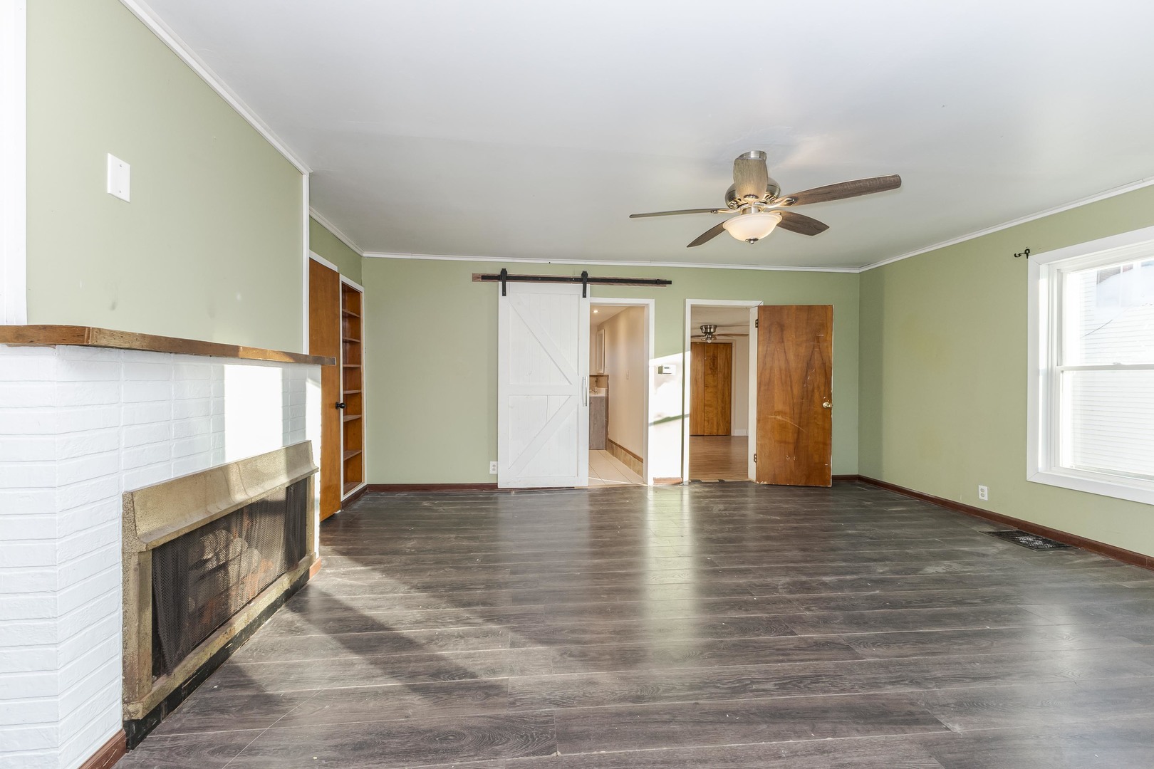 121 East James Street Forrest, IL 61741 - Photo 7 of 39 a view of an empty room with window and wooden floor