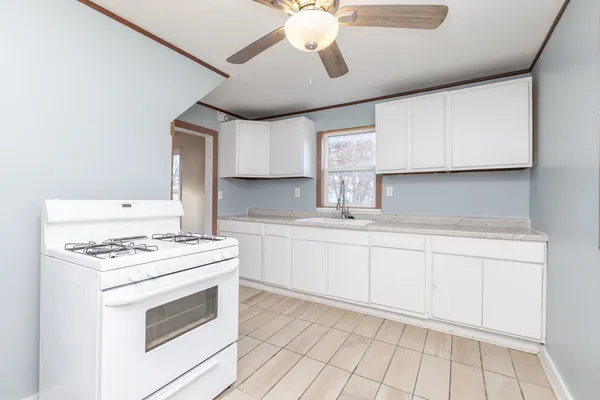 a kitchen with cabinets appliances and a sink