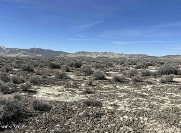 a view of a large mountain with mountains in the background