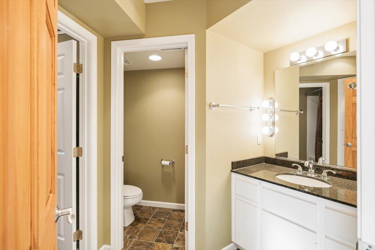 12531 Lowhills Road Nevada City, CA 95959 - Photo 55 of 92 a bathroom with a granite countertop sink toilet and shower