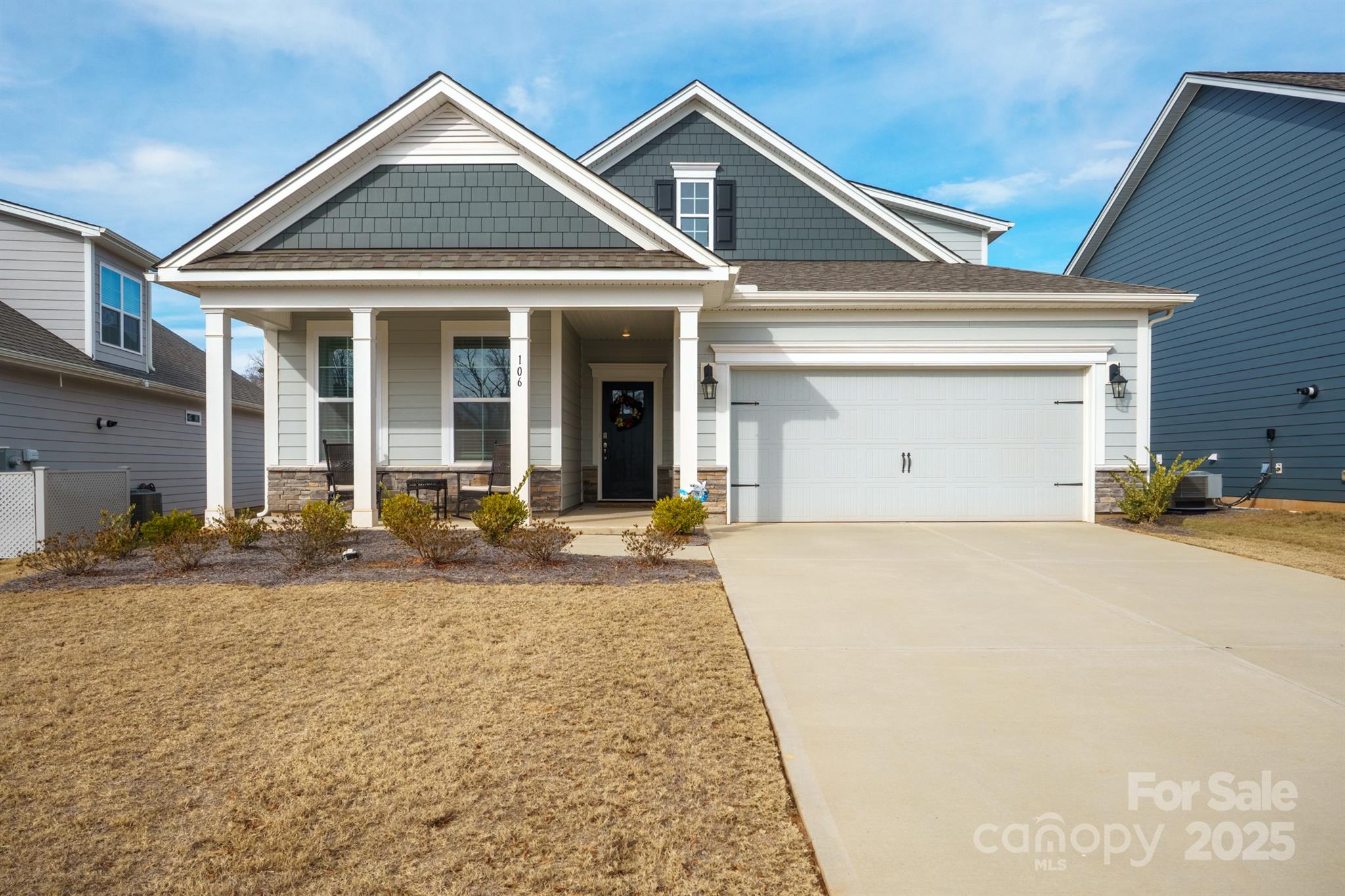 a front view of a house with a yard and garage