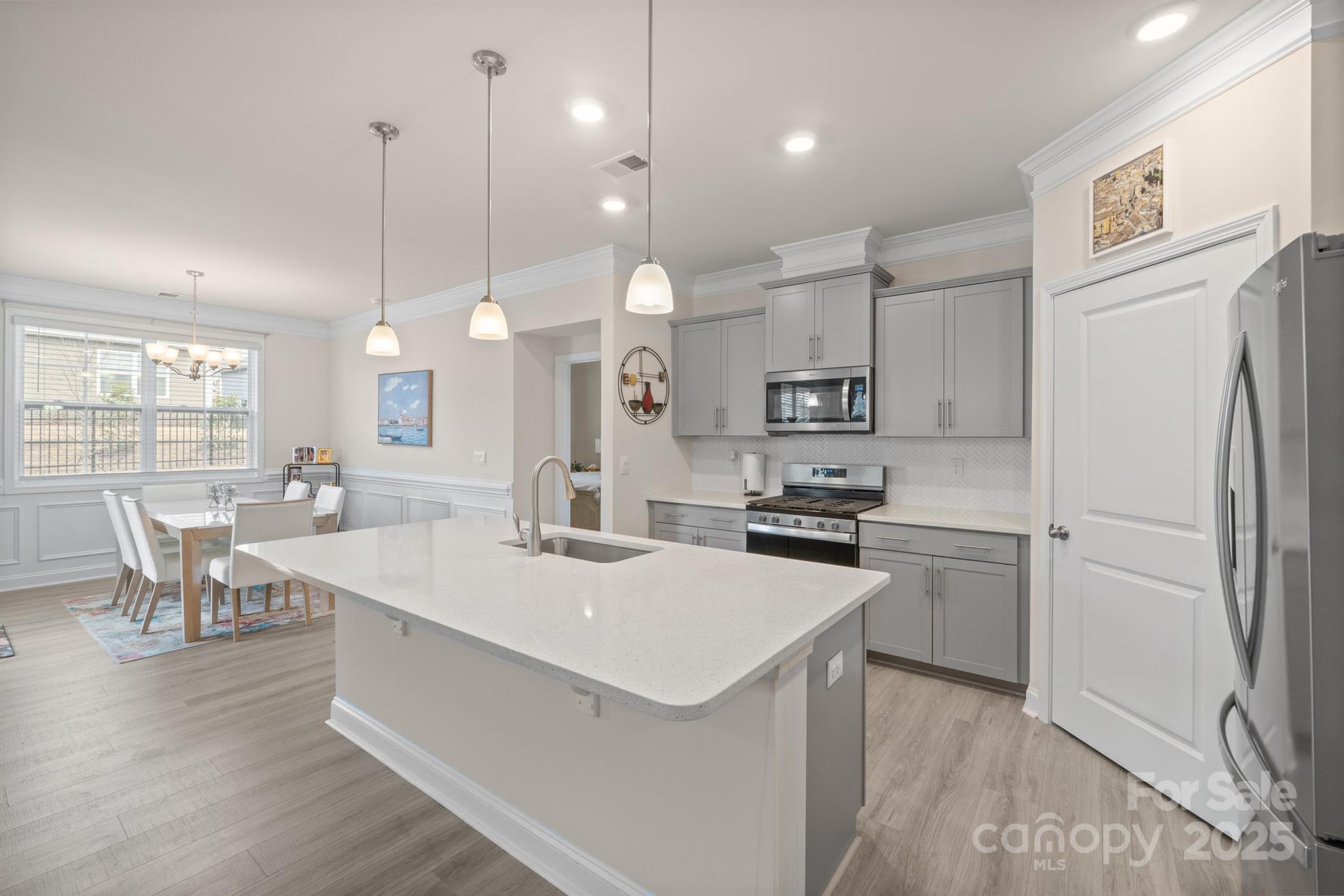 106 South Shayna Road Troutman, NC 28166 - Photo 5 of 41 a kitchen with white cabinets and stainless steel appliances