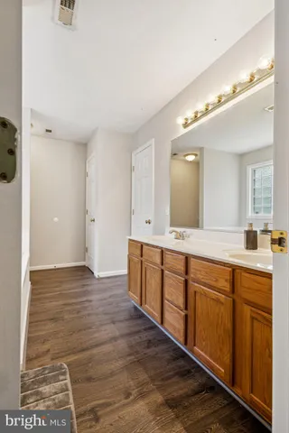 a spacious bathroom with a double vanity sink and a mirror
