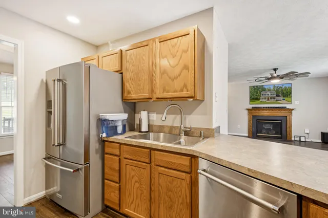 a kitchen with appliances a sink and a counter top space