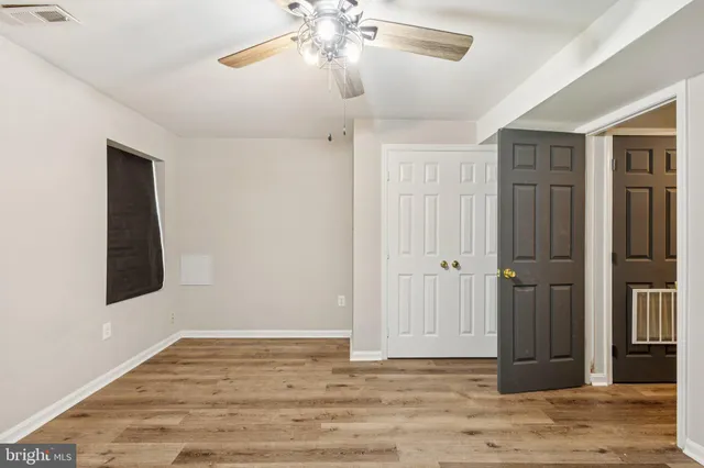 a view of an empty room with wooden floor