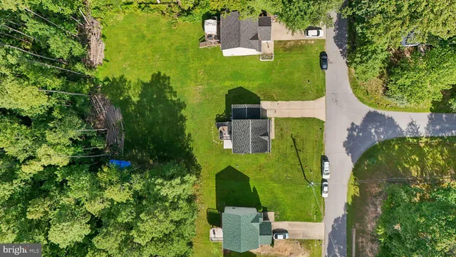 an aerial view of a house with a yard swimming pool outdoor seating and yard