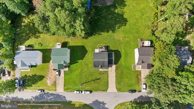 an aerial view of a house with a yard basket ball court and outdoor seating