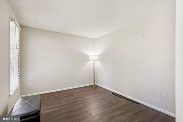 a view of wooden floor and cabinets in a room