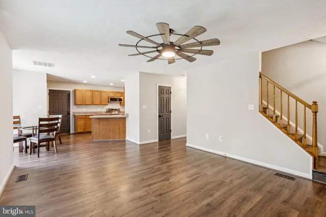 a view of a livingroom with furniture wooden floor chandelier