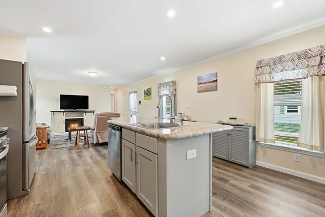 a kitchen with a sink stove and cabinets