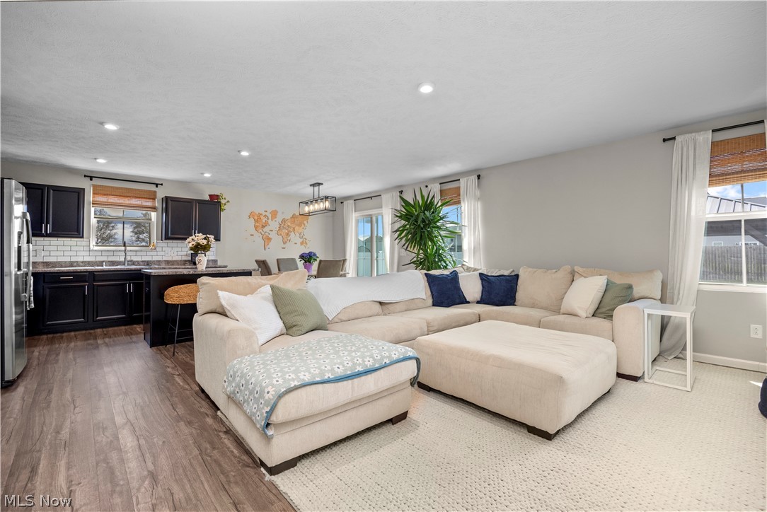 2161 Fowl Road Elyria, OH 44035 - Photo 11 of 46 Open-concept living space featuring wood-finish flooring, recessed lighting, and ample natural light from multiple windows