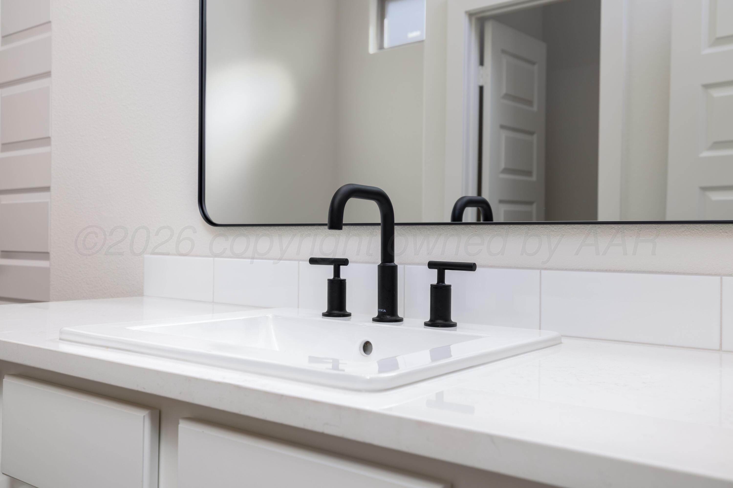 3107 Bluejay Road Amarillo, TX 79124 - Photo 12 of 14 a bathroom with a sink and a mirror