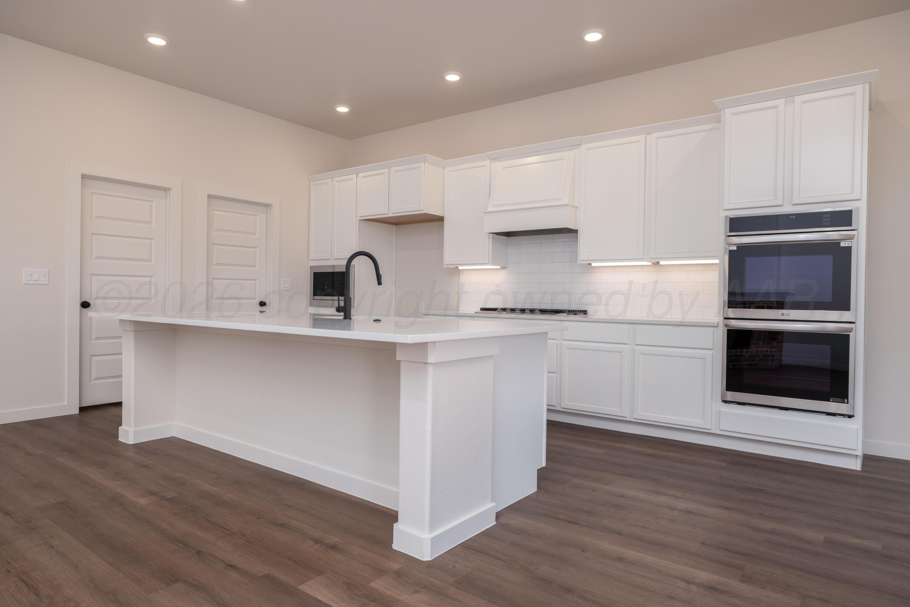 3107 Bluejay Road Amarillo, TX 79124 - Photo 2 of 14 a kitchen with a sink stainless steel appliances and cabinets