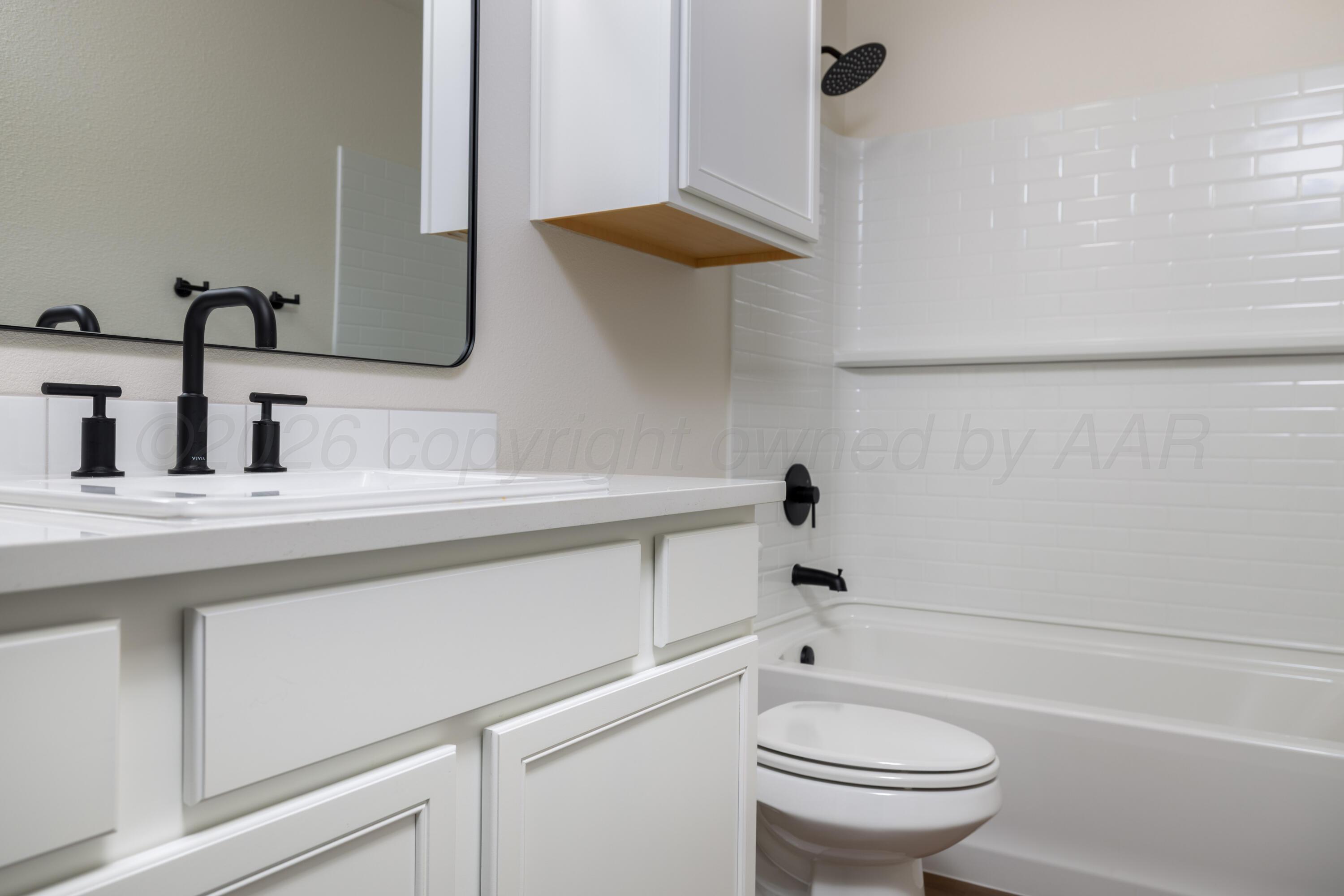 3107 Bluejay Road Amarillo, TX 79124 - Photo 7 of 14 a bathroom with a sink a toilet and shower