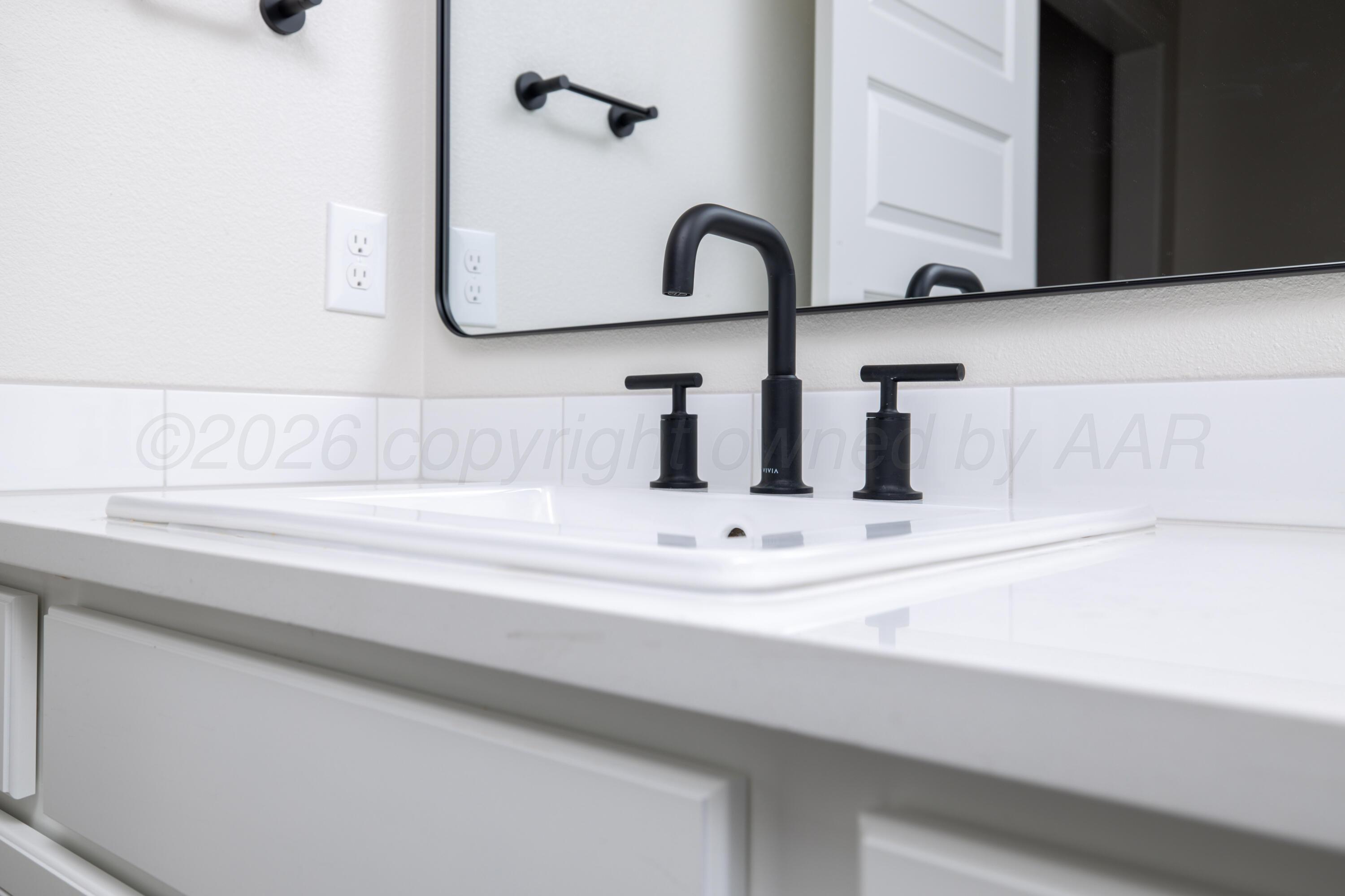 3107 Bluejay Road Amarillo, TX 79124 - Photo 8 of 14 a bathroom with a sink and a mirror