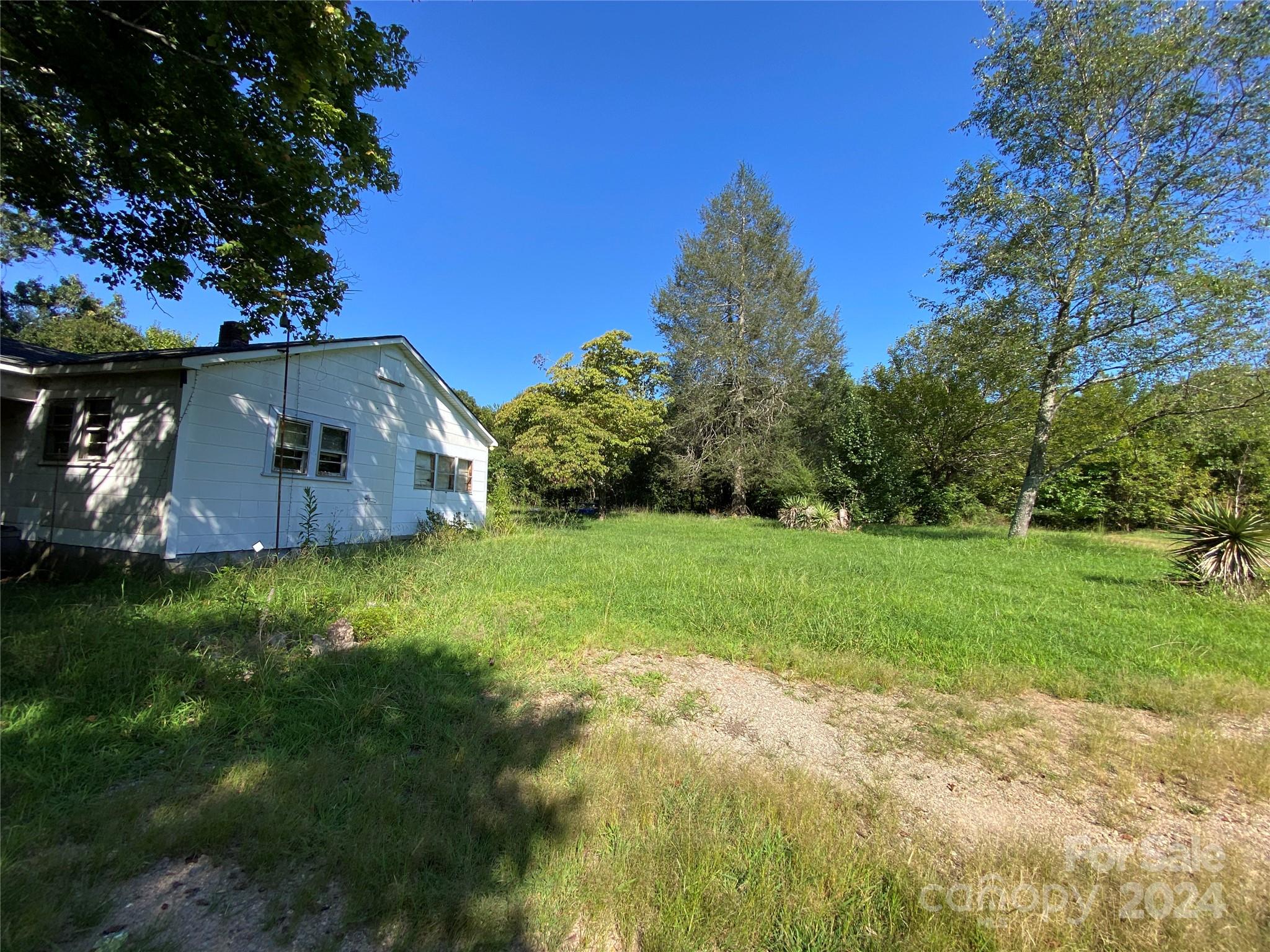 3140 Rutherford College Road Valdese, NC 28690 - Photo 32 of 40 a backyard of a house with lots of green space