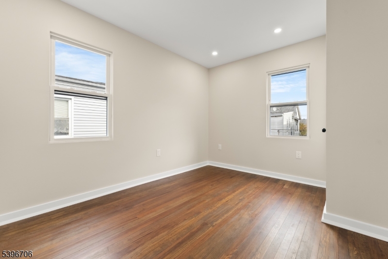 218 Ampere Parkway, Unit 2 Bloomfield, NJ 07003 - Photo 11 of 19 a view of an empty room with wooden floor and a window