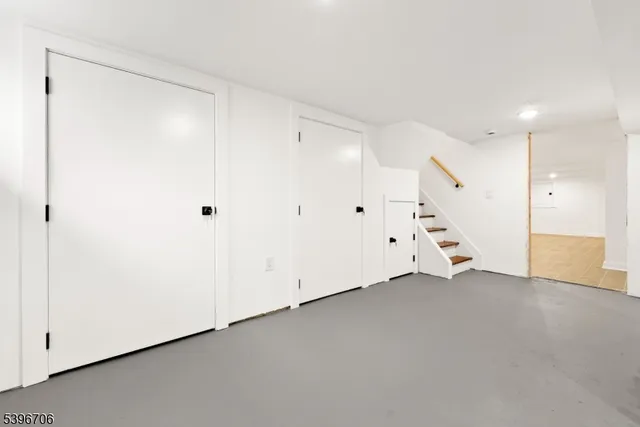 an empty room with a window and a ceiling fan