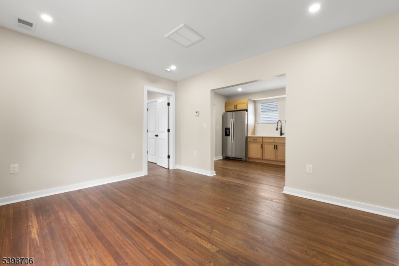 218 Ampere Parkway, Unit 2 Bloomfield, NJ 07003 - Photo 4 of 19 a view of an empty room with wooden floor and closet