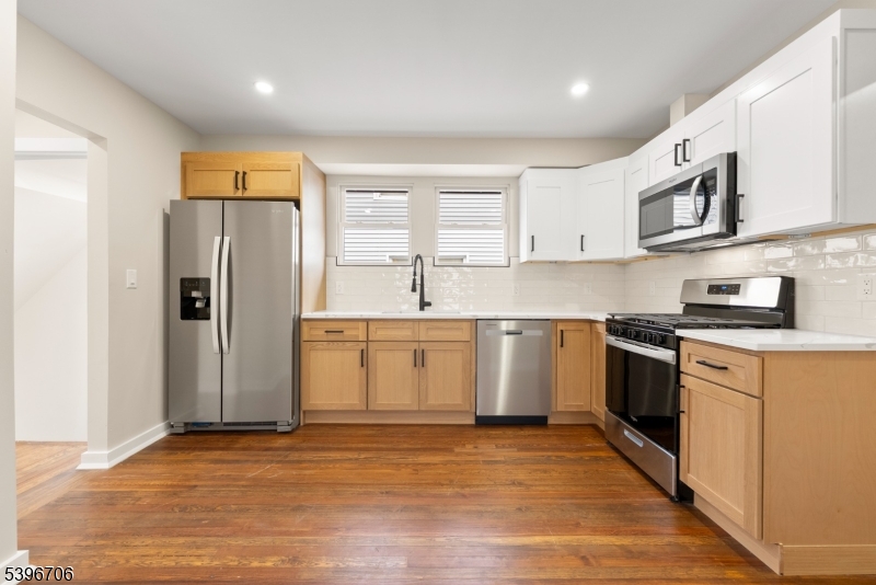 218 Ampere Parkway, Unit 2 Bloomfield, NJ 07003 - Photo 5 of 19 a kitchen with stainless steel appliances granite countertop a refrigerator and a stove top oven