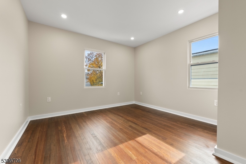 218 Ampere Parkway, Unit 2 Bloomfield, NJ 07003 - Photo 10 of 19 an empty room with wooden floor and windows