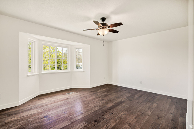 365 South Center Street Fielding, UT 84311 - Photo 14 of 41 Unfurnished room featuring dark wood-type flooring and a ceiling fan