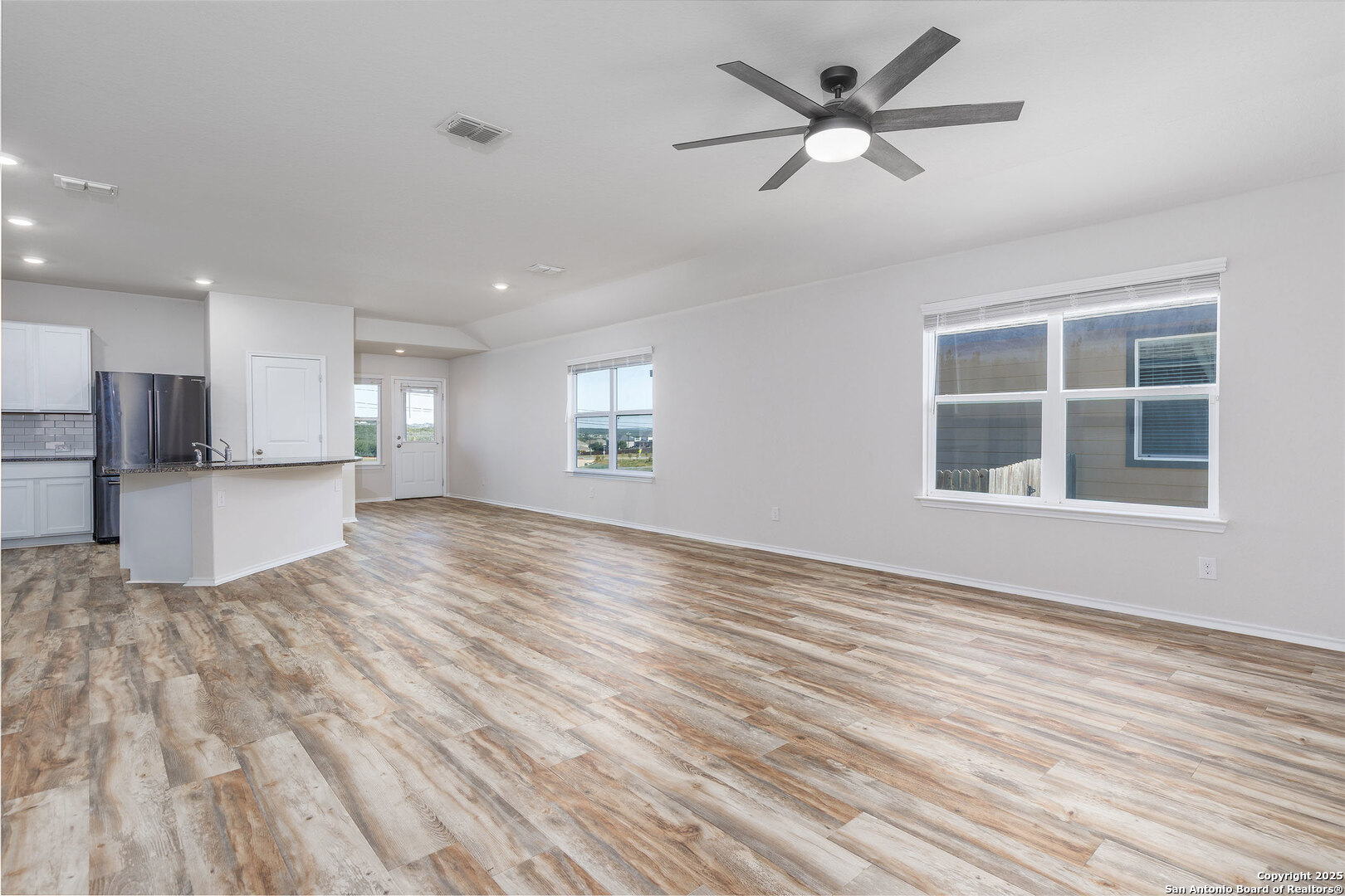 29714 Spring Copper Bulverde, TX 78163 - Photo 5 of 26 a view of an empty room with window and wooden floor