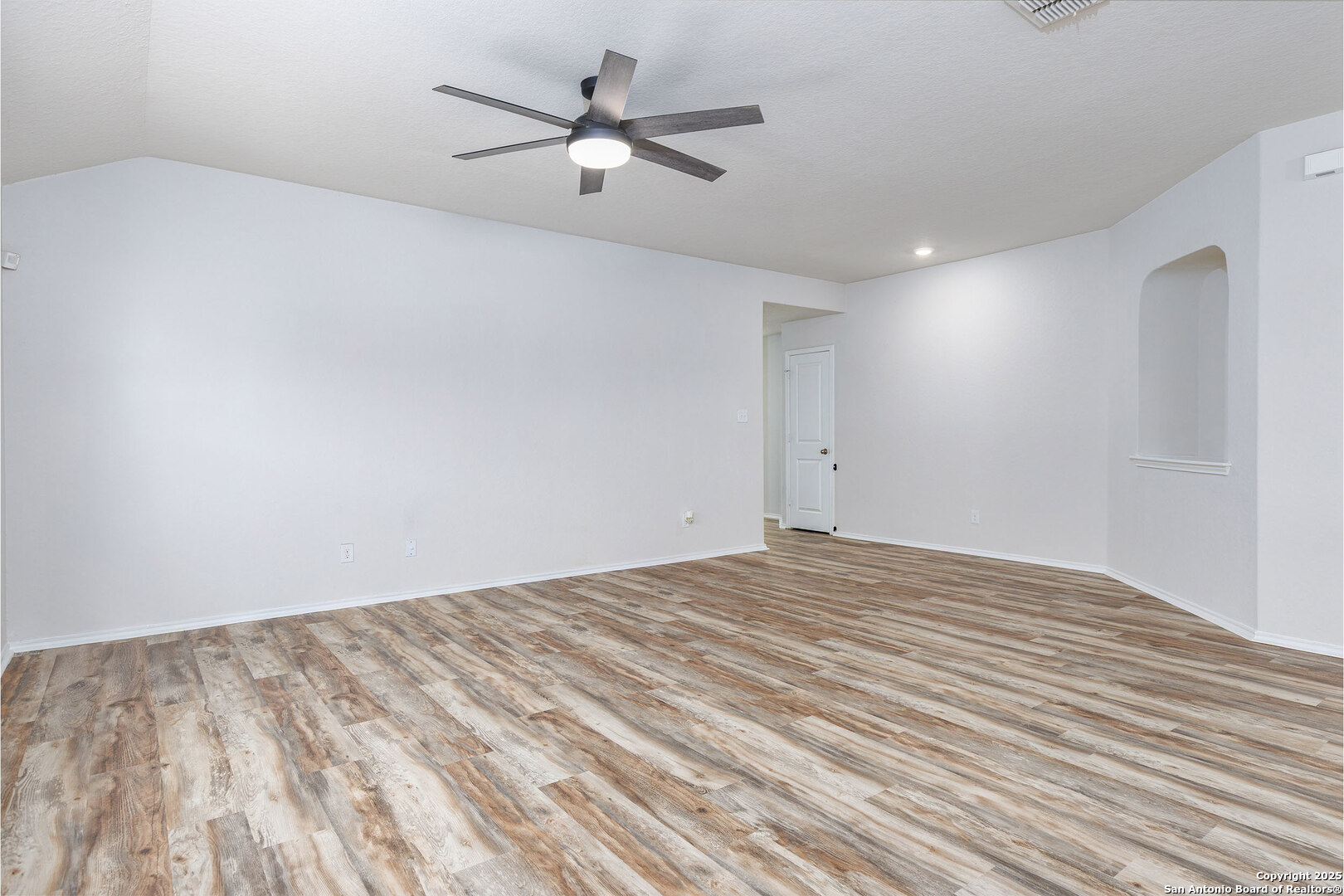 29714 Spring Copper Bulverde, TX 78163 - Photo 7 of 26 a view of a big room with wooden floor and a ceiling fan