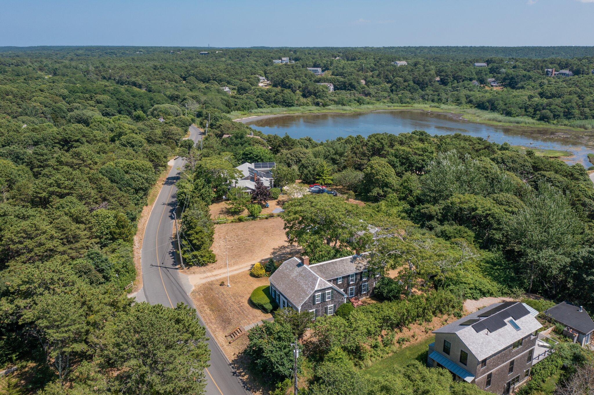 64 Depot Road Truro, MA 02666 - Photo 5 of 53 an aerial view of a house with a garden and lake view