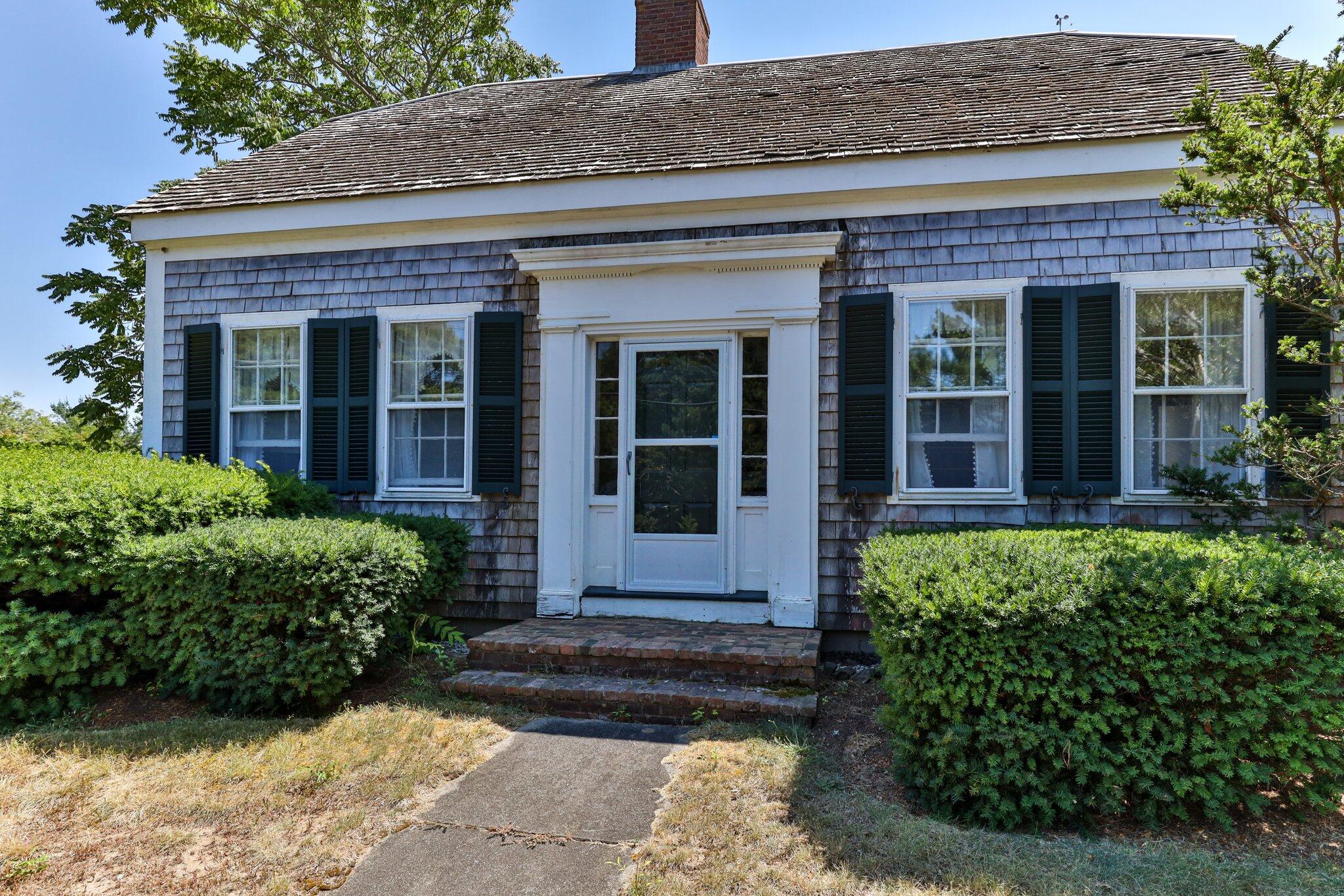 64 Depot Road Truro, MA 02666 - Photo 8 of 53 front view of a brick house with a large window
