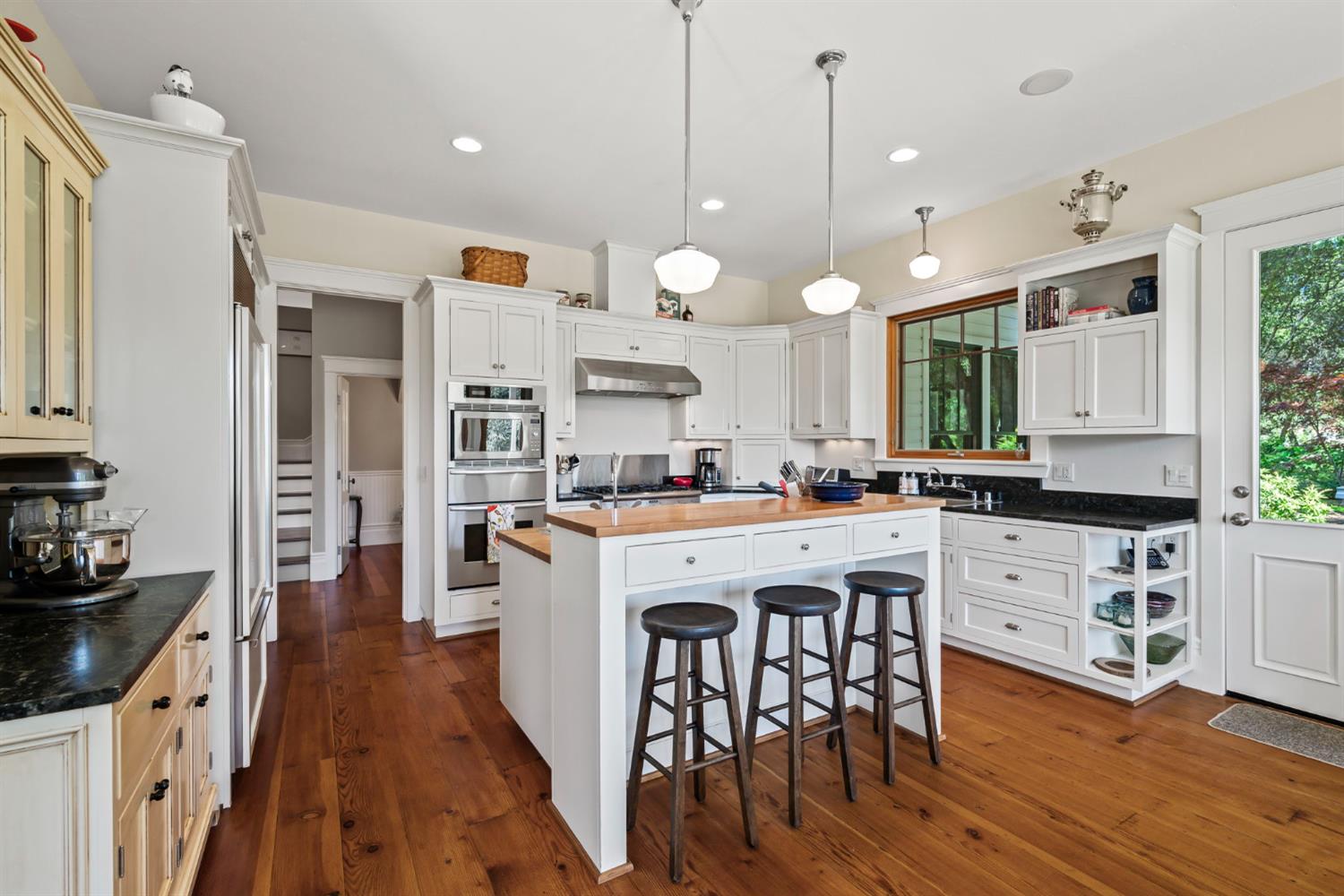 7407 Allen Lane Penryn, CA 95663 - Photo 15 of 83 a large kitchen with cabinets a sink a stove and wooden floor