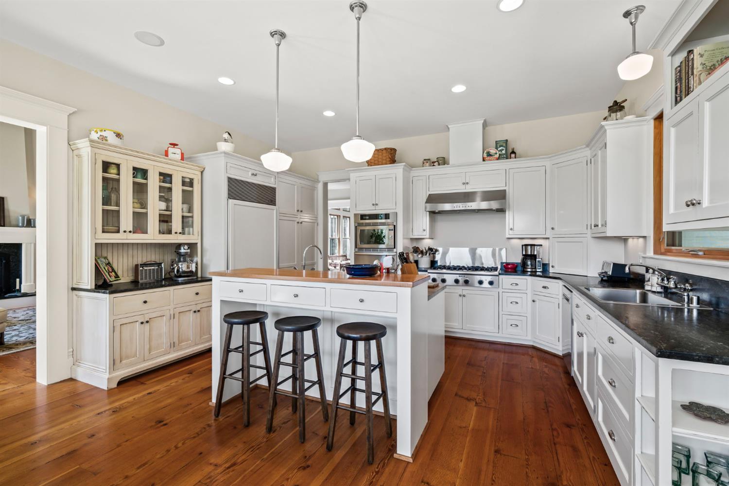 7407 Allen Lane Penryn, CA 95663 - Photo 16 of 83 a kitchen with stainless steel appliances granite countertop a stove a refrigerator a kitchen island a stove and white cabinets with wooden floor