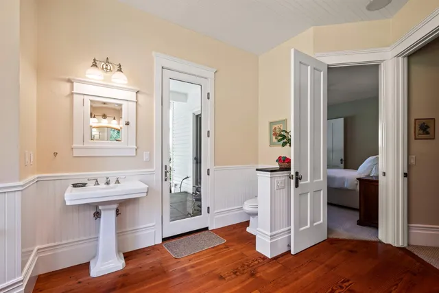 a view of a patio with table and chairs with wooden fence and plants