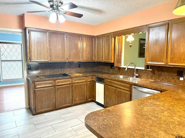 a kitchen with stainless steel appliances granite countertop a sink and cabinets