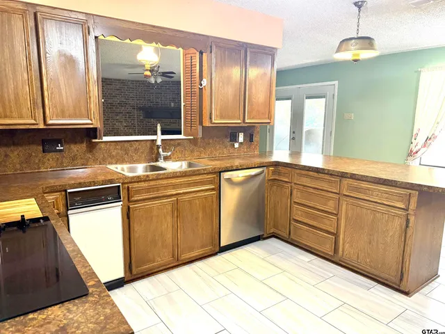 a kitchen with cabinets a sink and appliances