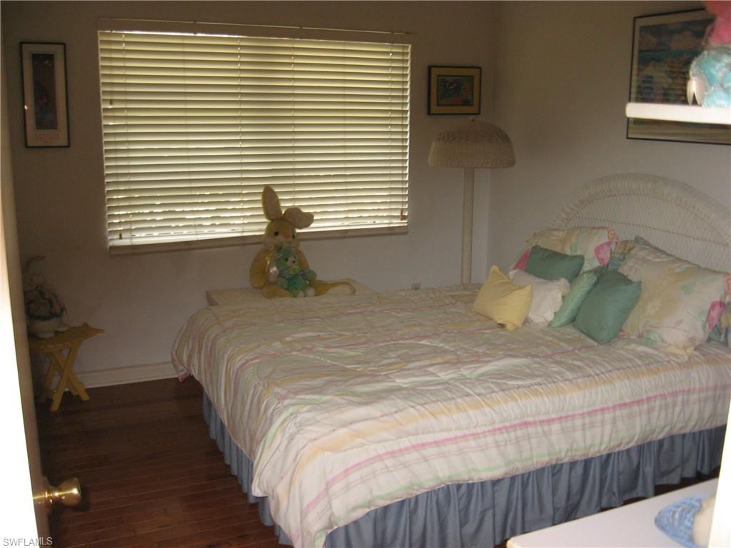 5150 Sand Dollar Lane Naples, FL 34103 - Photo 12 of 16 a bedroom with a bed and a window