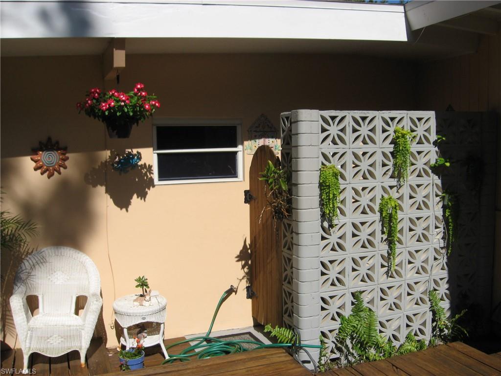 5150 Sand Dollar Lane Naples, FL 34103 - Photo 6 of 16 a vase of flowers sitting on a table
