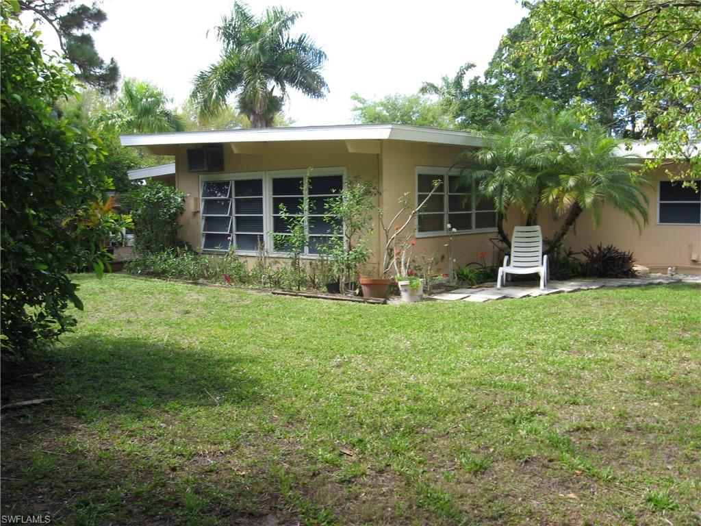 5150 Sand Dollar Lane Naples, FL 34103 - Photo 10 of 16 a house with garden in front of it