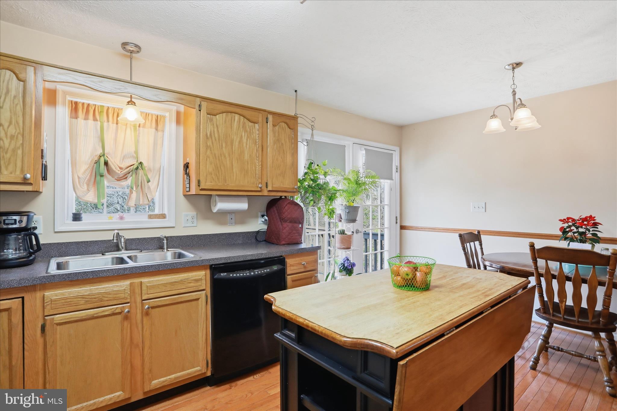 1158 Drummer Hill Road Front Royal, VA 22630 - Photo 11 of 36 a kitchen with a stove a sink a dining table and chairs