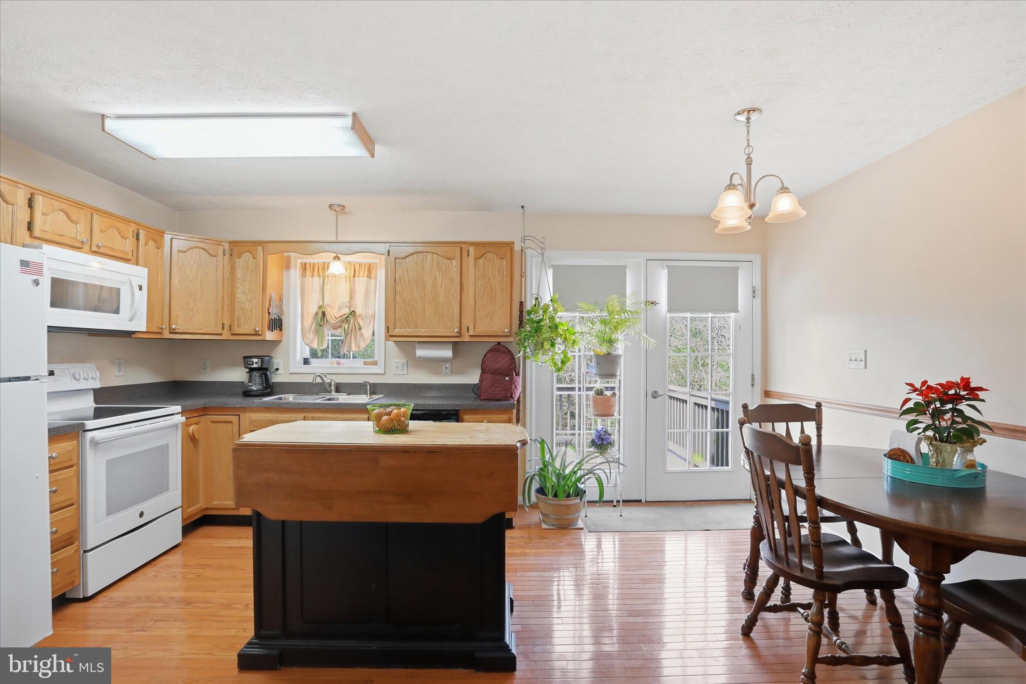 1158 Drummer Hill Road Front Royal, VA 22630 - Photo 14 of 36 a kitchen with a table chairs stove and cabinets