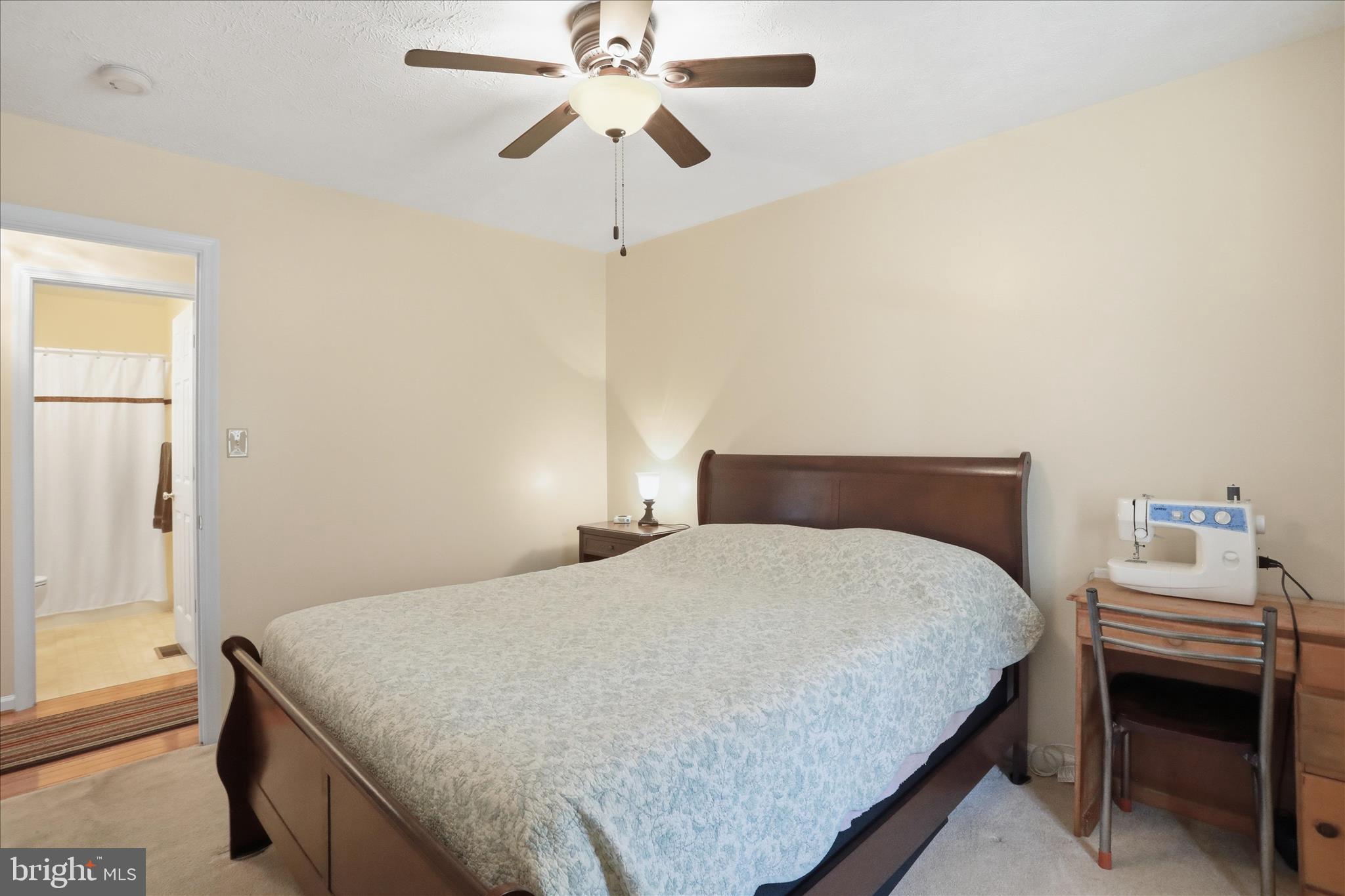 1158 Drummer Hill Road Front Royal, VA 22630 - Photo 18 of 36 a bedroom with a bed and a chandelier