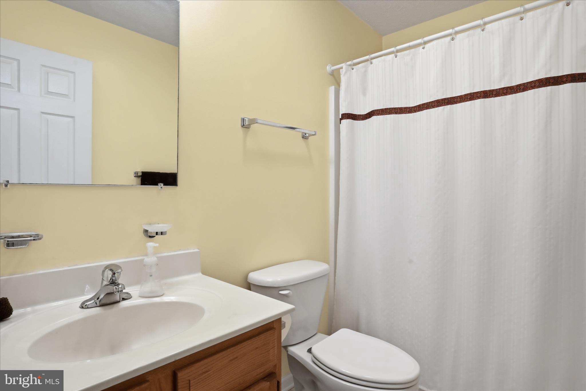 1158 Drummer Hill Road Front Royal, VA 22630 - Photo 22 of 36 a bathroom with a sink a toilet and shower curtain