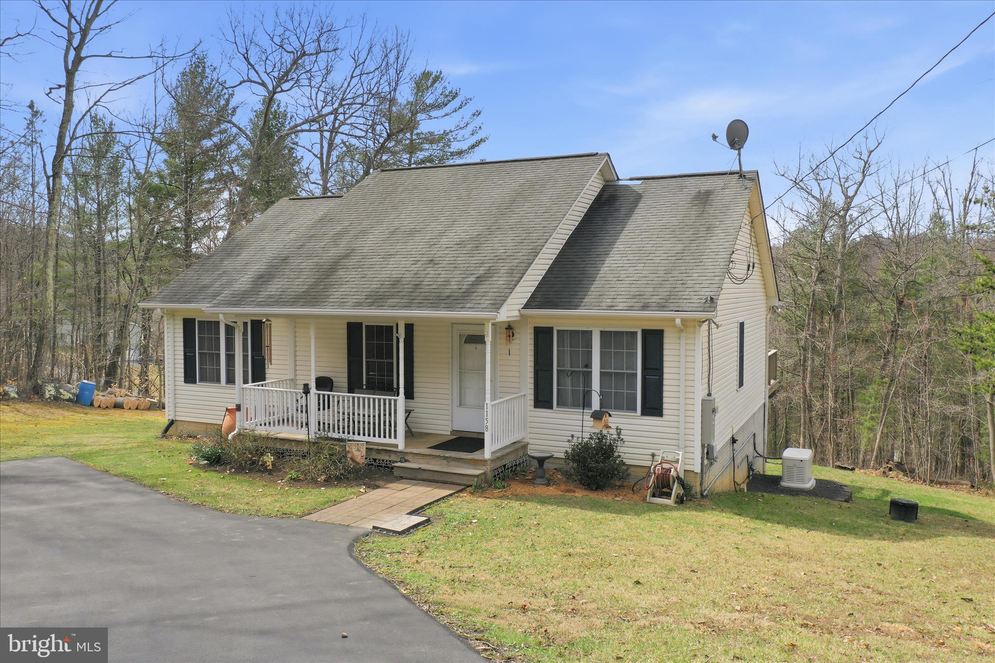 1158 Drummer Hill Road Front Royal, VA 22630 - Photo 27 of 36 a front view of house with a garden and patio