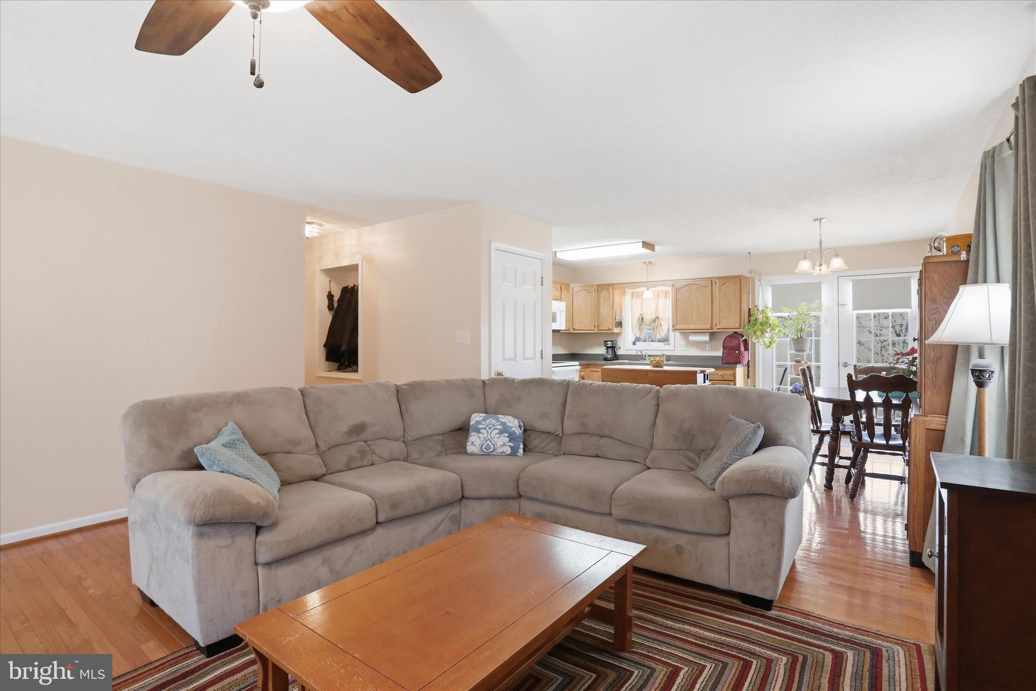 1158 Drummer Hill Road Front Royal, VA 22630 - Photo 2 of 36 a living room with furniture white walls and a dining table with wooden floor