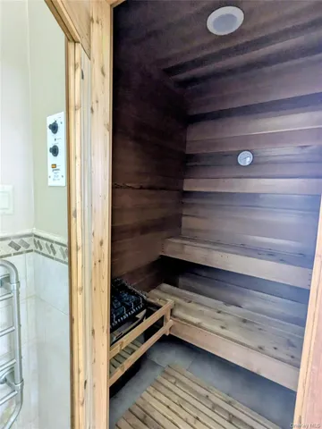 a bathroom with a shower mirror and a sink