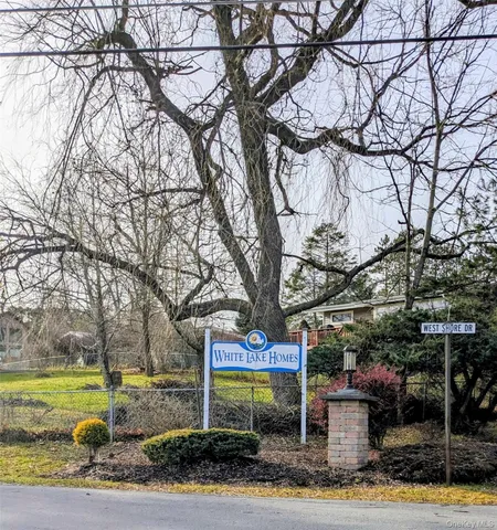 a view of a hallway with wooden floor and windows