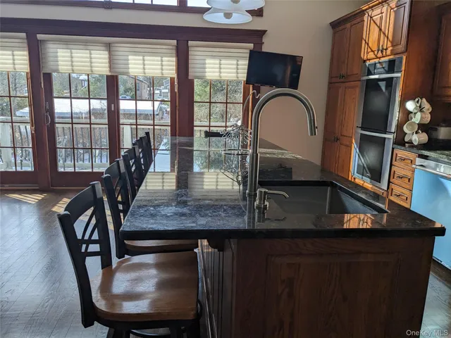 a view of a livingroom with furniture window and wooden floor