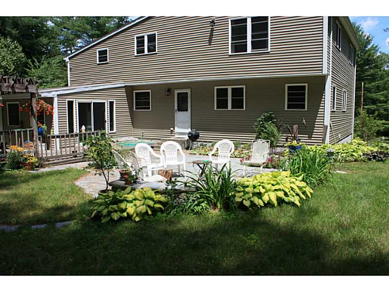 42 Anthony Road Foster, RI 02825 - Photo 1 of 25 Exterior Back. Sunroom off the back leads to the patio. Take walks on your own private trails in the woods.
