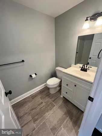 a bathroom with a sink toilet and a mirror